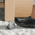 Close-up of the total-lock brake mechanism on a 5 inch caster, showing both wheel and swivel lock engaged